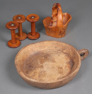A carved elm basket 23cm x 23cm, a large circular carved dish 44cm diam. and 3 mounted bobbins 18cm x 25cm
