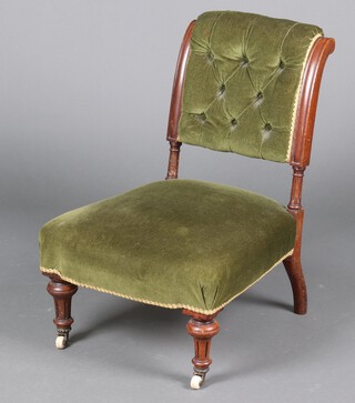 A Victorian beech framed nursing chair upholstered in green buttoned material 69cm h x 48cm w x 49cm d (movement to frame) 