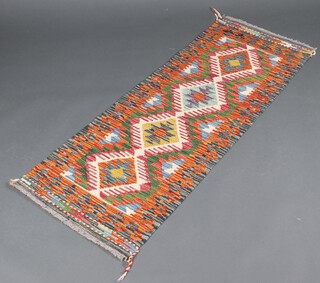 A yellow, green and turquoise ground Chobi Kilim runner with 4 diamonds to the centre 149cm x 59cm