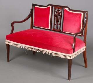 An Edwardian Chippendale style mahogany double chair back settee upholstered in red material, raised on square tapered supports 89cm h x 117cm w x 52cm d (old repair and break and a small section missing to the left arm)