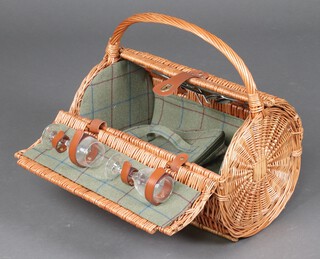 A cylindrical wicker picnic hamper complete with cutlery, 2 china plates and 2 glasses 32cm h x 47cm w x 31cm d 