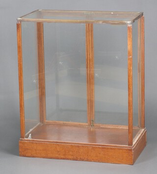 An oak and metal bound display cabinet enclosed by glazed panelled doors 85cm h x 69cm w x 37cm d 