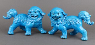 A pair of modern turquoise glazed figures of standing Shi Shi 20cm (1 is stuck)