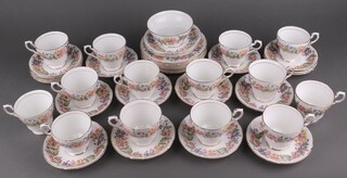 A Paragon Country Lane pattern part tea service comprising 14 tea cups, 17 saucers, sugar bowl, 7 side plates, 2 large saucers 