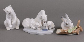 A Lladro group of a family of polar bears 1443 9cm, a seated polar bear 12cm and a rabbit before a trunk 4773 7cm (chipped)