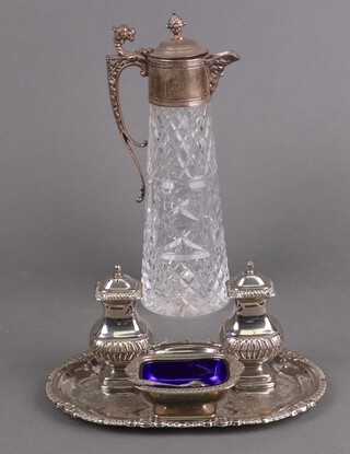 A silver plated mounted moulded glass ewer, a 3 piece condiment and tray 