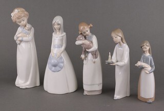 Three Lladro figures - girl holding a lamb 22cm, girl holding a candle 19cm, girl holding a piglet 17cm and 2 other porcelain figures
