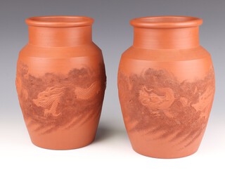 A pair of Chinese tan glazed baluster vases decorated with dragons amongst clouds 24cm (minor chips clouds)
