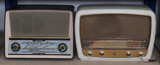 A Ferranti Type U1003 radio contained in a brown Bakelite case and a Phillips Mk.40009 radio in a white Bakelite case 