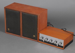 A Leak stereo 30 plus amplifier contained in a teak case together with 2 Wharfdale speakers contained in teak cabinets