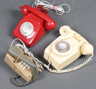 A red dial telephone no.746, a white wall telephone and a Trim phone