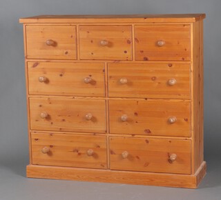 A pine chest of 3 short and 6 long drawers with turned handles 122cm h x 132cm w x 41cm d 