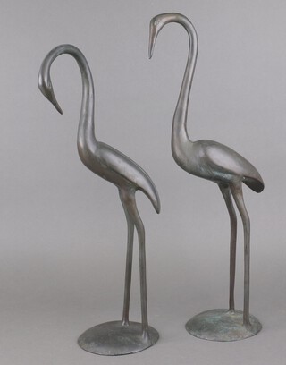 A pair of bronze figures of storks, on circular bases 60cm h x 15cm 