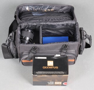 An Olympus OM-2n camera together with a RCM Tokina 35-70MM lens, in carrying case