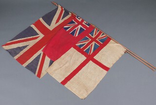 An Edwardian white printed cloth Ensign and pole, flag 47cm x 84cm, together with red Ensign and a Union flag 