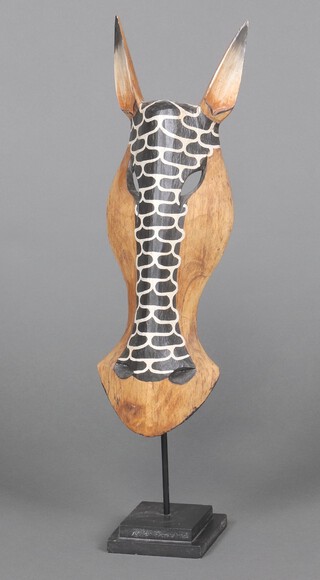 An African hardwood sculpture in the form of a zebra mask 64cm h 