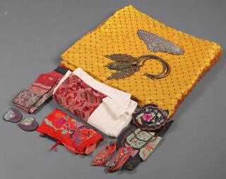 An Eastern gilt fabric throw together with a collection of other fabrics, Chinese shoes etc, contained in a fruit box 