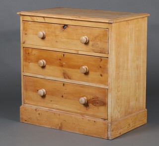 A 19th Century pine chest of 3 drawers with turned handles, raised on a platform base 84cm h x 85cm w x 50cm d 