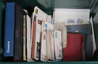 An album of GB first day covers, stock book of GB stamps and a collection of first day covers, all in a green plastic box 