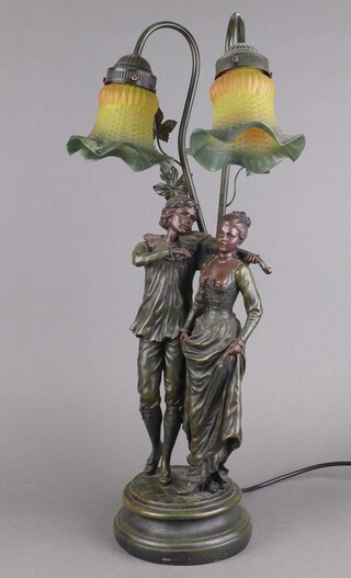 An Art Nouveau style bronzed table lamp in the form of a standing violinist and lady, with amber twin light shades 62cm h x 16cm 