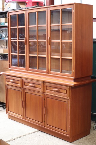 Dyrlund, a Danish mid-century teak display cabinet/dresser, the raised back fitted cupboards enclosed by astragal glazed panelled doors, the base fitted 3 drawers above 3 cupboards enclosed by panel doors 188cm h x 164cm w x 50cm d 