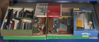 A small collection of N gauge rolling stock and rails, together with N gauge buildings