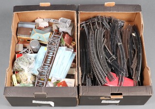 A quantity of OO gauge track and plastic model railway layout buildings, contained in 2 fruit boxes and a plastic box