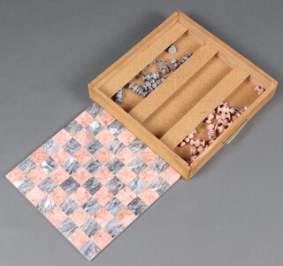 An onyx chess set complete with board 35cm x 35cm, contained in a wooden carrying case