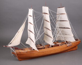A wooden model of a 3 masted sailing ship 59cm h x 88cm w x 10cm d 