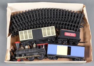 A large gauge plastic push along train set, locomotive tender and 2 wagons 