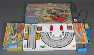 A Matchbox M2 motorway game and an Matchbox E-2 set complete with transformer 