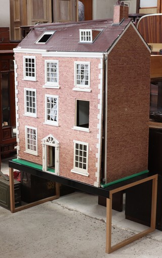 A dolls house 84cm h x 74cm w x 40cm d, raised on a separate stand 