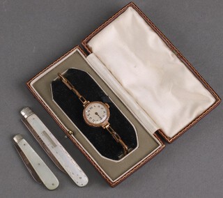 A lady's gilt cased wristwatch and 2 silver mounted fruit knives 