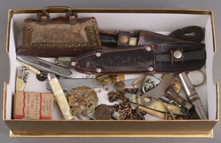 An RAF brooch, buttons, a mother of pearl folding pocket knife, a childs bangle and other curios 