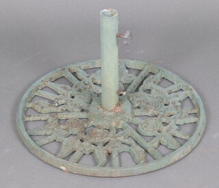A circular cast iron pierced and green painted garden parasol base 38cm h x 58cm diam. 