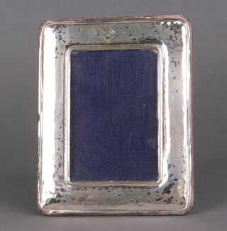 A rectangular silver photograph frame 16cm x 14cm (dented) and 1 other 
