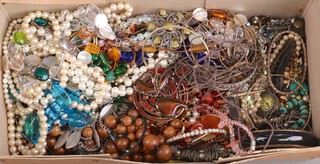 A quantity of vintage costume jewellery including brooches, beads, etc