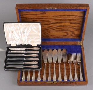 A set of 6 silver handled butter knives and a set 6 fish knives and forks 