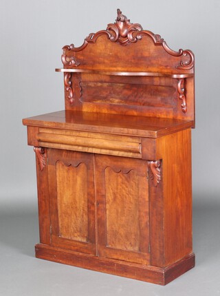 A Victorian carved mahogany chiffonier with raised back fitted a shelf, the base fitted a drawer above cupboard enclosed by a pair of panelled doors 148cm h x 91cm w x 41cm d 