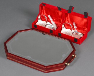 A mirrored octagonal tray and 2 plated double bird bowls and spoons 