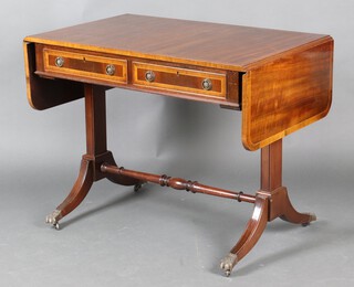 A reproduction Georgian mahogany sofa table, raised on standard end supports with paw feet 75c h x 94cm w x 61cm d 