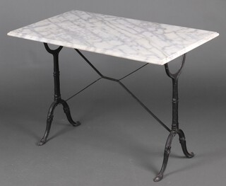 A rectangular iron and white marble garden table 70cm h x 160cm diam. 
