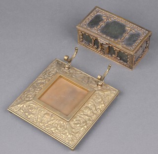 A 19th Century rectangular leather and gilt metal bound trinket box in the form of a coffer 5cm x 13cm x 7cm together with a Victorian cast brass inkwell stand decorated The Green Man 15cm 