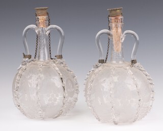 A pair of 19th Century Dutch 2 handled glass decanters engraved with windmills, fruits and boats, having metal stoppers  21cm (1 a/f)