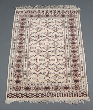 A white and blue ground Turkoman Bokhara rug, the centre with stylised medallions 129cm x 93cm 