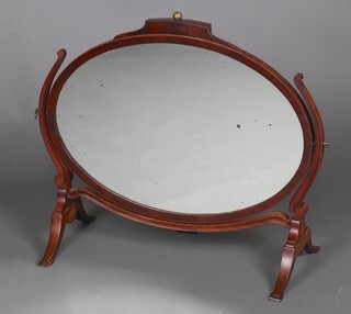 A 19th Century oval plate dressing table mirror in an inlaid mahogany frame with gilt ball finial to the top 66cm h x 77cm w x 33cm d (silvering to the mirror is showing signs of deterioration)