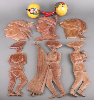 Three South American carved wood wall plaques of figures, 3 ditto of indigenous Indians and a pair of maracas 