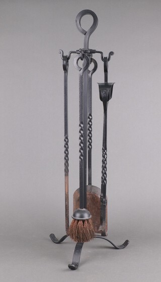 A wrought iron 3 piece fireside companion set comprising tongs, poker, shovel and brush 72cm x 28cm