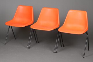 Hille, a set of 3 Robin Day design mid-century tubular metal and orange moulded plastic stacking chairs 75cm h 