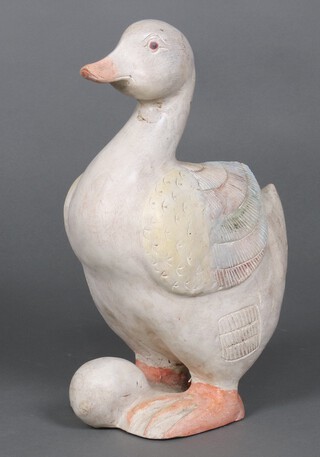 A carved wooden figure of a duck with an egg 45cm x 31cm 
